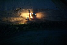 Combine Harvestor On Field During Night Shift Aerial Drone View Panorama,harvest In Europe	