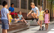 © JackF - Little boy jumping on rubber band with friends in historical center outdoor