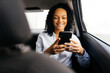 © kleberpicui - Businesswoman using smartphone in the car