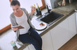 © lenets_tan - Smiling woman online shopping using tablet and credit card in kitchen