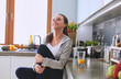 © lenets_tan - Smiling woman online shopping using tablet and credit card in kitchen