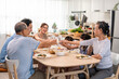 © Kawee - Asian big happy family have lunch on eating table together in house.