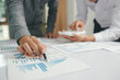 © ijeab - Asisan businessman teamwork meeting and discussing the investment data and report graph.