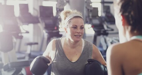 Canvas Print - Boxer, athlete and fighter boxing, training and exercising in a gym, hitting a punching bag and working out for cardio and endurance. Chubby, plus size and overweight woman practicing for a fight