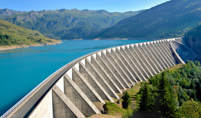 the roselend dam with turquoise water in a mountainous landscape in France