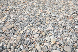 Fototapeta Desenie - Pile of pebbles on shingle beach as background