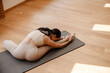 © Drobot Dean - Young white woman doing exercise on mat during yoga practice