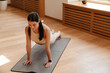 © Drobot Dean - Young white woman doing exercise on mat during yoga practice