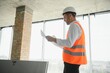 © Serhii - Portrait of man architect at building site. Confident construction manager wearing hardhat. Successful mature civil engineer at construction site with copy space.