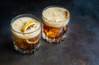 © RooM The Agency - Close-up of two cola drinks with ice cubes and slices of orange