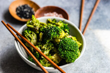 Close-up Of A Bowl Of Broccoli With Sesame Seeds And Pink Himalayan Salt