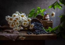 Still Life With Honeysuckle In A Bowl And A Bouquet Of Daisies On An Old Wooden Table