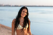 © Syda Productions - people, summer and swimwear concept - happy smiling young woman in bikini swimsuit on beach