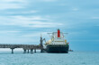 © Evgeny - liquefied natural gas carrier tanker during loading at an LNG offshore terminal, in the distance the oil export terminal is visible in the sea