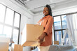 © Syda Productions - moving, people and real estate concept - happy smiling woman holding box at new home