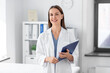 © Syda Productions - medicine, healthcare and profession concept - smiling female doctor with clipboard at hospital