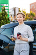 © frimufilms - Young woman with an electric car at charging station in Chisinau, Moldova