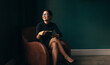 © Jacob Lund - Businesswoman sitting on armchair with cup of tea