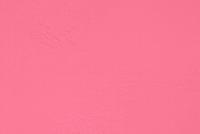Saturated Pastel Pink Colored Low Contrast Concrete Textured Background. Empty Colourful Wall Texture With Copy Space For Text Overlay And Mockups. 2023, 2024 Color Trend