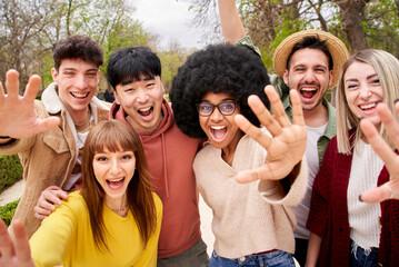 Wall Mural - Group of cheerful young friends taking selfie portrait. Students at university campus. Happy people looking at the camera smiling. Concept of community, youth lifestyle and friendship.