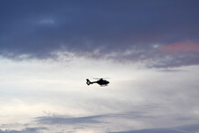 Silhouette Of Helicopter Flying In The Sky