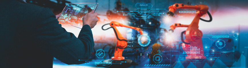 Wall Mural - Industry engineer control robotics automatic arms in factory,using smart tablet glass device,machine learning operation,concept business and industry 4.0,Artificial intelligence or AI,with 5G network