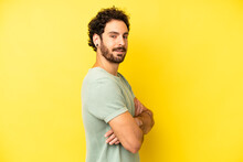 Young Bearded Man Smiling To Camera With Crossed Arms And A Happy, Confident, Satisfied Expression, Lateral View