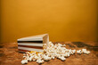 © LoloStock - Popcorn on a wooden table against yellow background