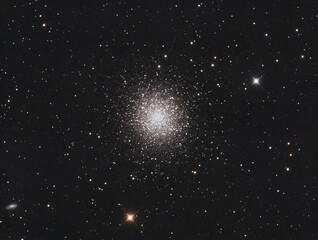 Wall Mural - messier 13 globular cluster in hercules constellation, with many stars as background and a galaxy on