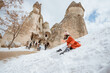 © Odua Images - happy little girl in red sliding on a pile of snow in pasabag valley cappadocia