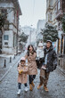 © Odua Images - portrait of asian family wearing warm clothing standing in the middle of snow fall in winter. family travel in turkey