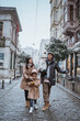 © Odua Images - happy asian family traveling in beautiful city during snow fall winter in turkey