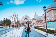 Male Tourist Visiting Hagia Sophia. Man Smiling In Front Of Turkey Most Popular Mosque Attraction