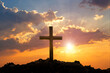 The silhouette cross standing on meadow sunset and flare background. Cross on a hill as the morning sun comes up for the day. The cross symbol for Jesus christ. Christianity, religious, faith, Jesus .