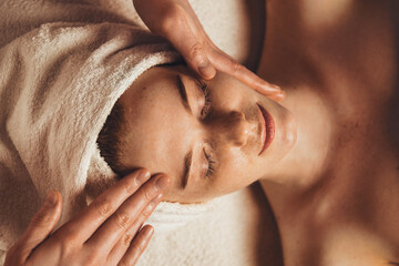 Wall Mural - relaxed woman lying on spa bed prepared for facial treatment in luxury spa salon. facial beauty trea