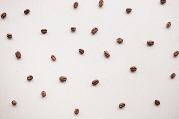 Pattern of roasted coffee beans arrange on brown paper background