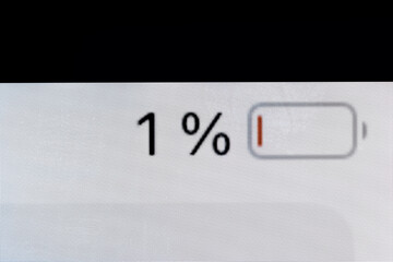 Low level of smartphone charged pixel battery level indicator - one, 1 percent: close up macro view of gadget display, screen. Energy, technology, power, digital and symbol concept