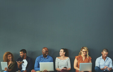 Aufkleber - Group of happy business people sharing information on wireless technology in a row at an office together. Corporate professionals sitting and talking using devices in a waiting room together at work