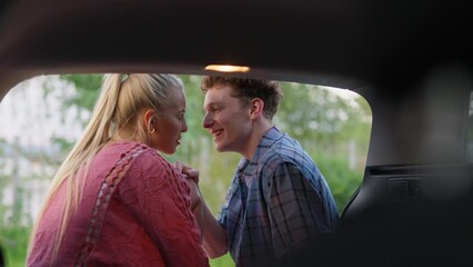 Wall Mural - Young couple in love camping together in car, enjoying holiday time, vertical footage.