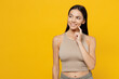 Young minded latin woman 30s she wear basic beige tank shirt look aside on workspace area mock up copy space prop up face isolated on plain yellow backround studio portrait. People lifestyle concept.