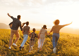 Poster - Happy family: mother, father, children son and daughter on sunset