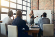 © Nola Viglietti/peopleimages.com - Confident, leadership and power by a business woman doing a presentation on a board to a group in a conference room. Happy woman explaining an idea or marketing strategy for a startup to investors