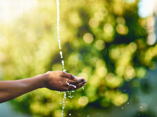 Closeup of hands catching fresh water outdoors, having fun in nature and practicing good hygiene. Person washing their fingers in a clean stream, enjoying splashing and refreshing germ free hydration