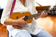© Austockphoto - cropped view of older person playing ukulele
