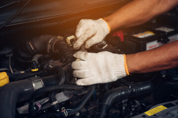 Closeup of auto mechanic are using the wrench to repair and maintenance auto engine is problems at car repair shop.