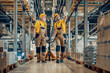 © ivanko80 - Two workers in uniform at warehouse