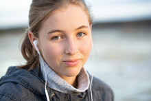 Teenager Looking At Camera With Music In Ears