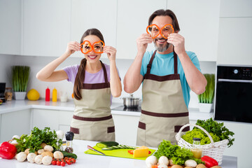 Sticker - Portrait of two excited positive people hold paprika slices make glasses look camera kitchen indoors