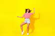 Leinwandbild Motiv Full body photo of brunette hooray lady dance wear t-shirt shorts sneakeers isolated on yellow color background