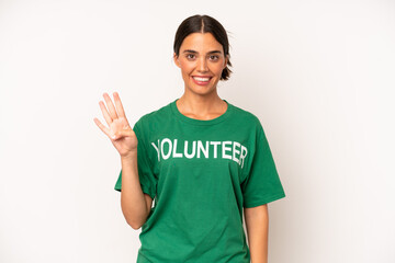 Wall Mural - pretty hispanic woman smiling and looking friendly, showing number four. ecology and volunteer concept